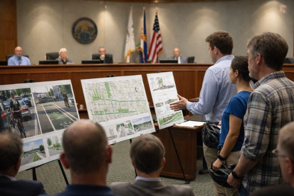 Cycling advocates presenting infrastructure proposals at local government meeting