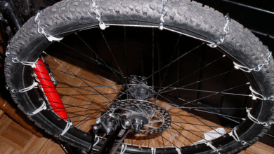 DIY bike tire chains installed on mountain bike wheel showing chain segments secured with cables and zip ties