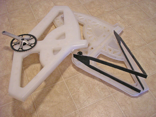 IV-1 plastic bicycle components disassembled showing polypropylene frame parts, internal spaceframe structure, and assembly pieces
