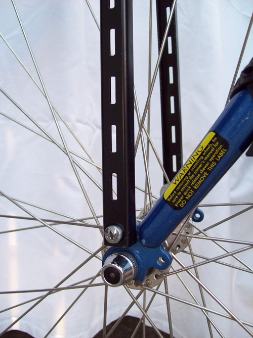 2. Using a predrilled hole, if available, attach each upright to the bottom of the fork in the existing holes.