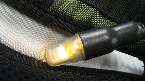 Backpack Bike Light LED module showing illuminated light embedded in a backpack strap for cyclist visibility.