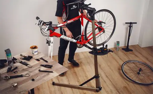 Best bike repair stands showing L-shaped and tripod base designs with mounted bicycles