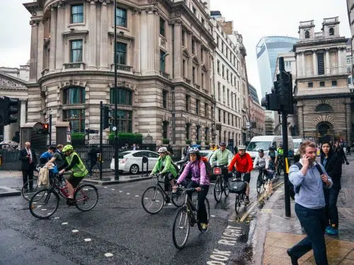 Bike commuters wearing helmet on morning commute through a city