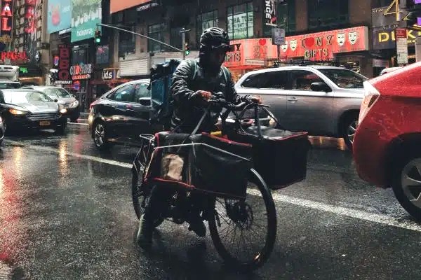 Bike commuter wearing reflective jacket and helmet with lights attached