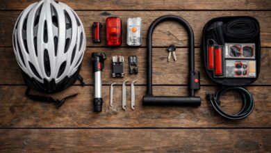 Essential bike commuting gear laid out including helmet, lights, lock, and repair kit