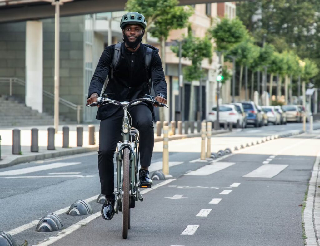 Bike commuter riding through city street transitioning from bike commuting to travel cycling lifestyle