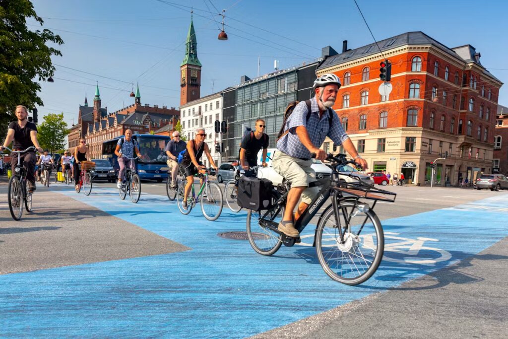 Cyclists using protected bike lanes in Europe showing how bike commuting to travel cycling works internationally